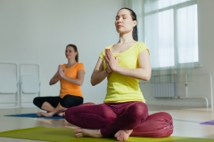 two women practicing yoga