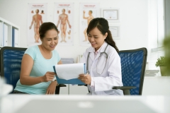 Female doctor showing test results to patient