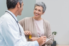 patient with medication speaking with their doctor 