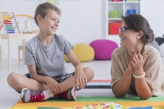 child with autism with school therapist